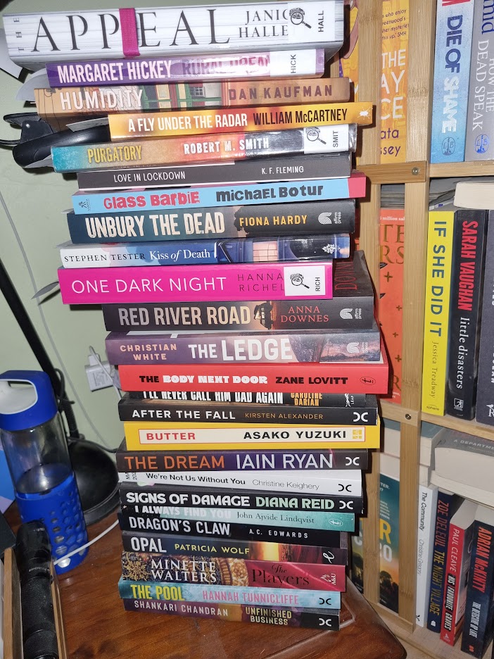 The obligatory reading stack pile which is teetering on the edge of the bedside table.